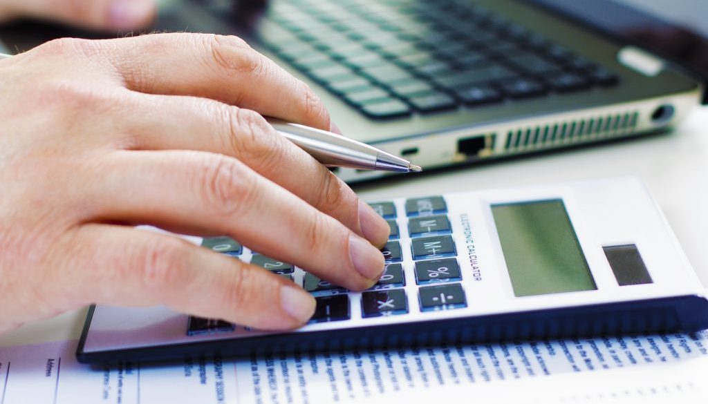 Business man in dark suit whit calculator